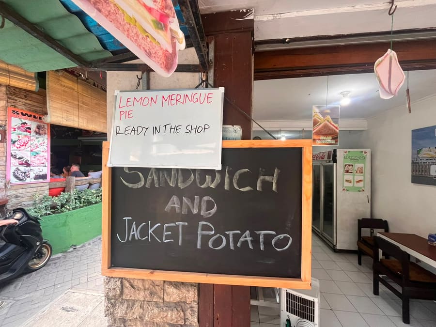 Sandwich and jacket potato chalkboard outside the shop
